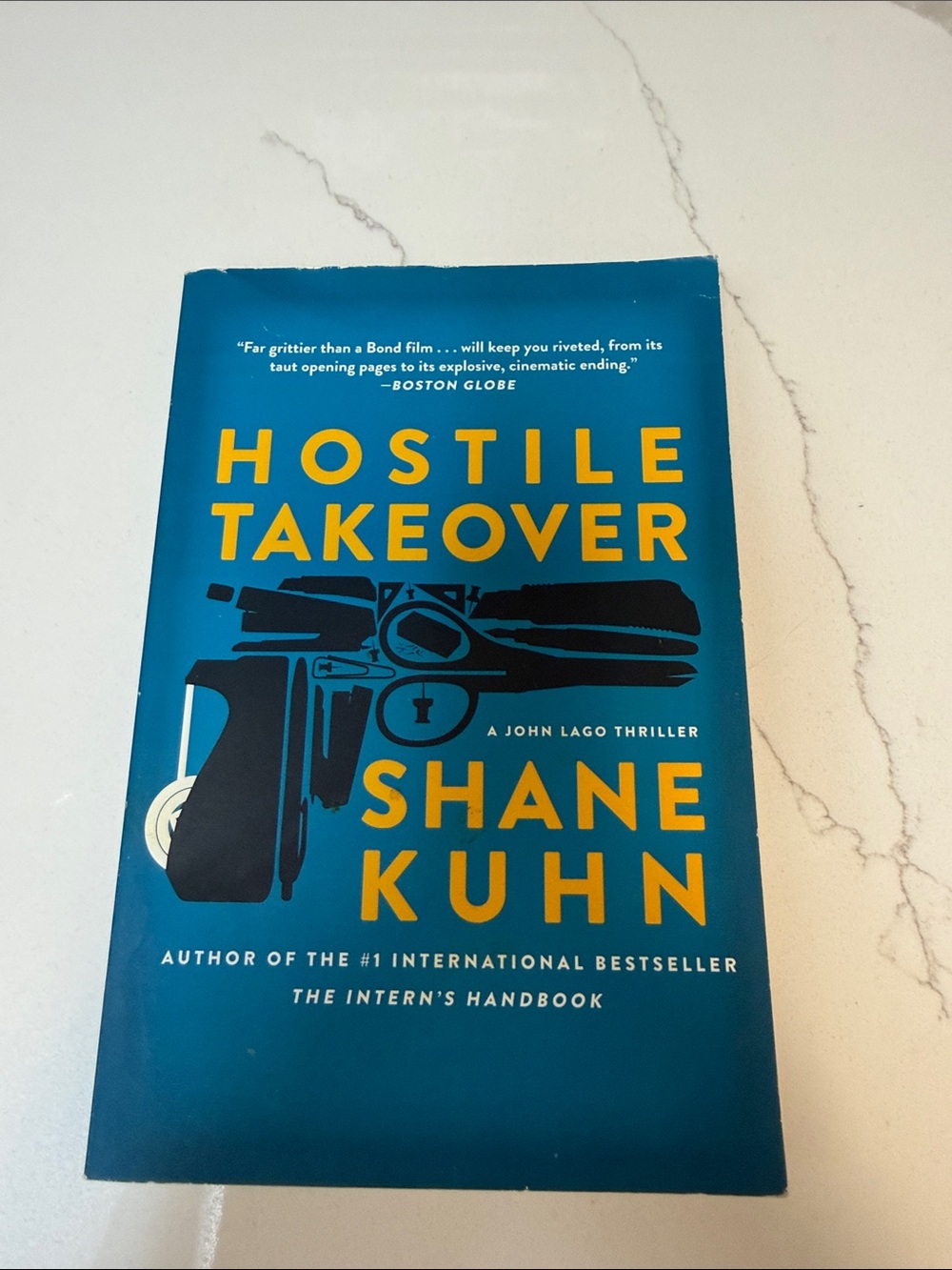 Hostile Takeover by Shane Kuhn - Blue Paperback Thriller